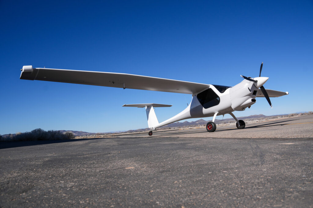 Image of the aircraft. Wide wings, single prop engine on the front. Short 2 seater cockpit.